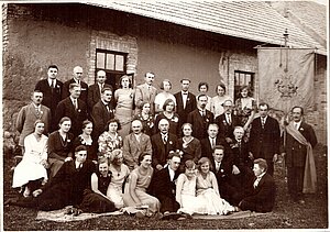 Bikstu koris 1931.gada jūlijā pie biedrības nama. 2. rindā sēž trešā no labās - Ledus kundze, viņai blakus Roberts Ledus. 4. rindā otrā no labās - Helēna Ledus. Foto: Maijas Zeipiņas arhīvs