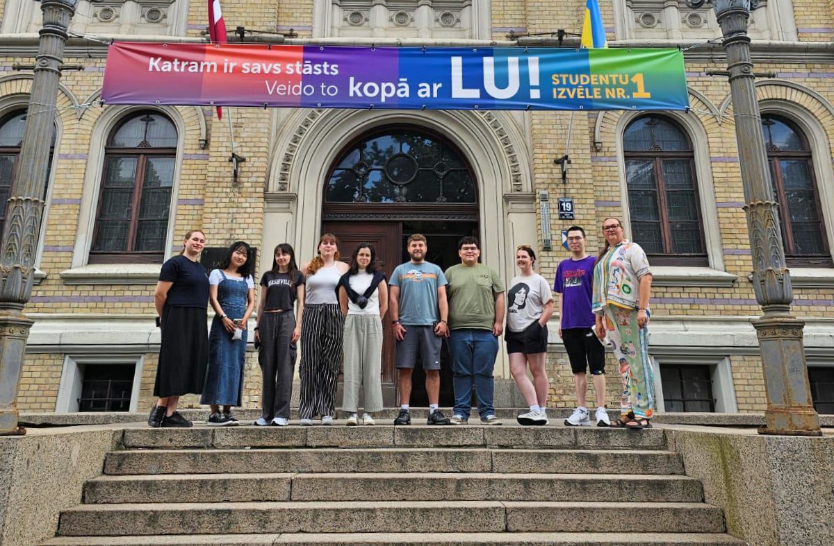 Students standing on the stairs outside of the University of Latvia
